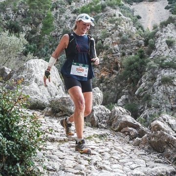 runner navigating a rocky trail in a mountainous landscape