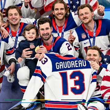celebration of a hockey team holding medals and a jersey